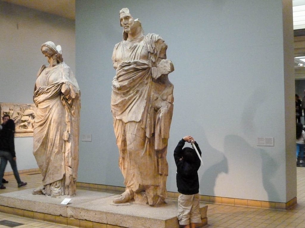 kid with sword and statue