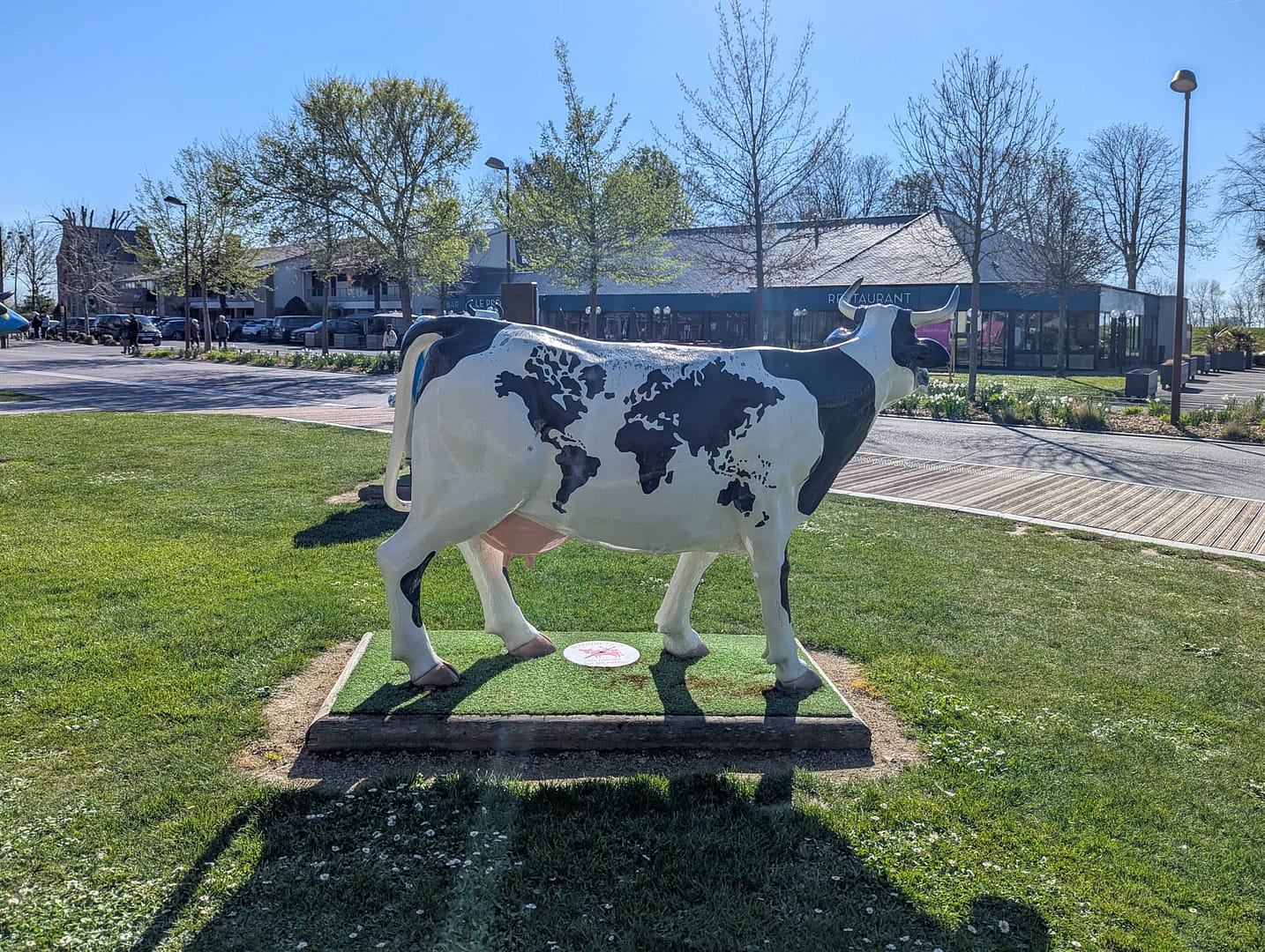 cow statue with world map spots