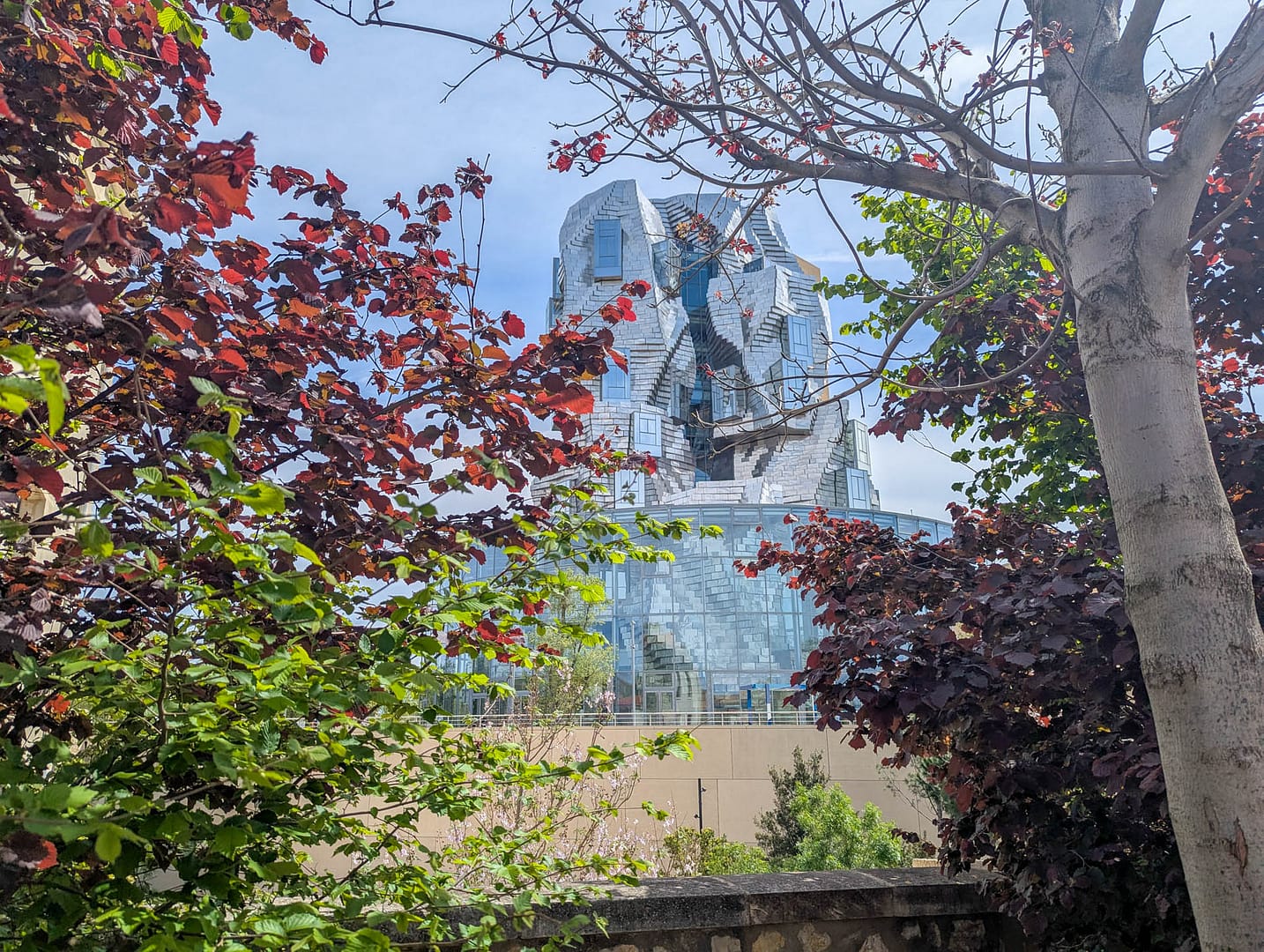 modern tower with flowering tree in foreground