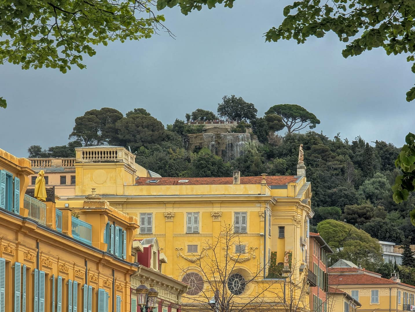 yellow building with hill in background