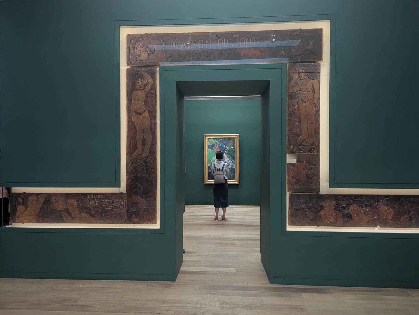 hallway with person looking at art