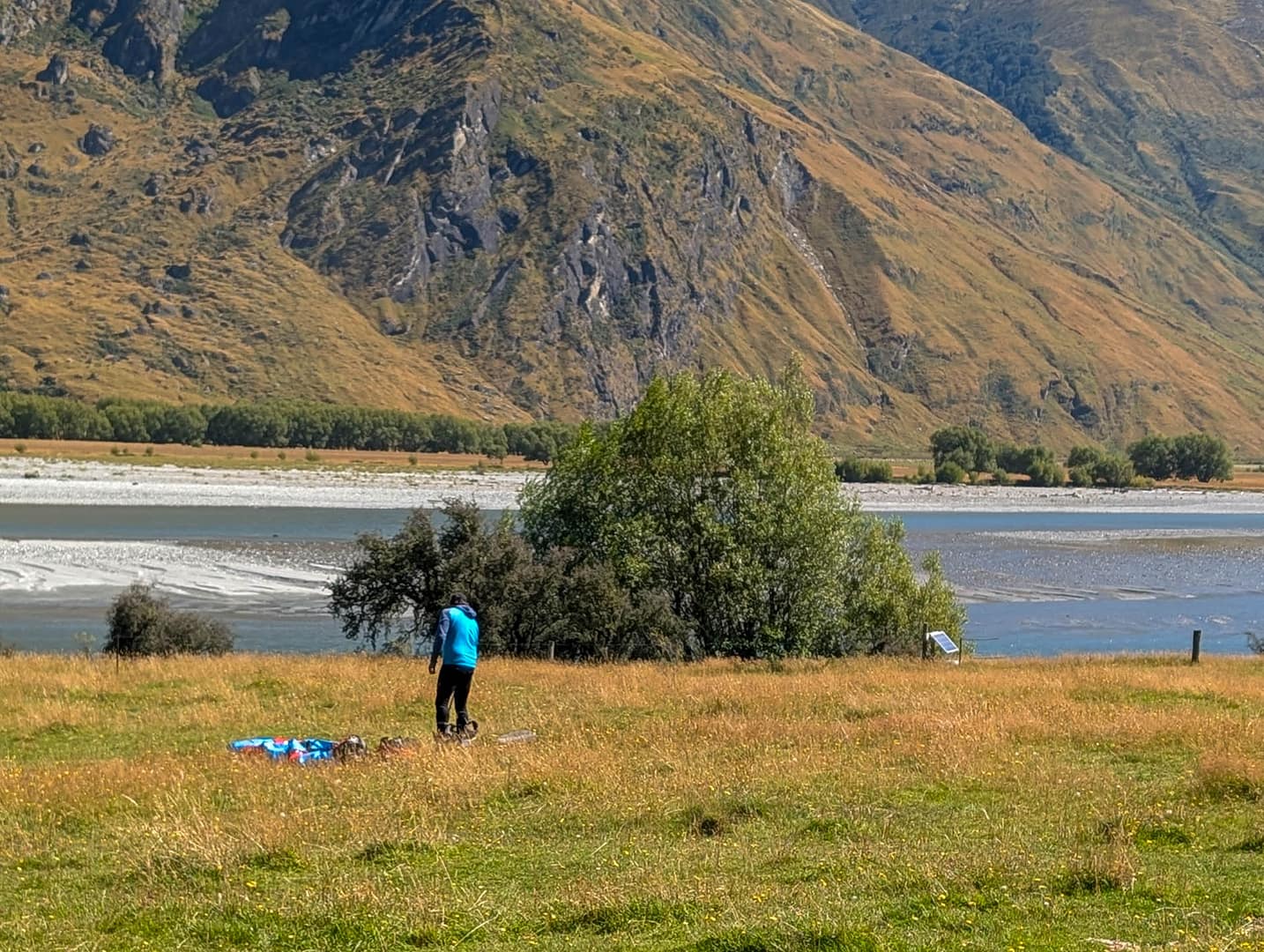 paraglider with gear in field