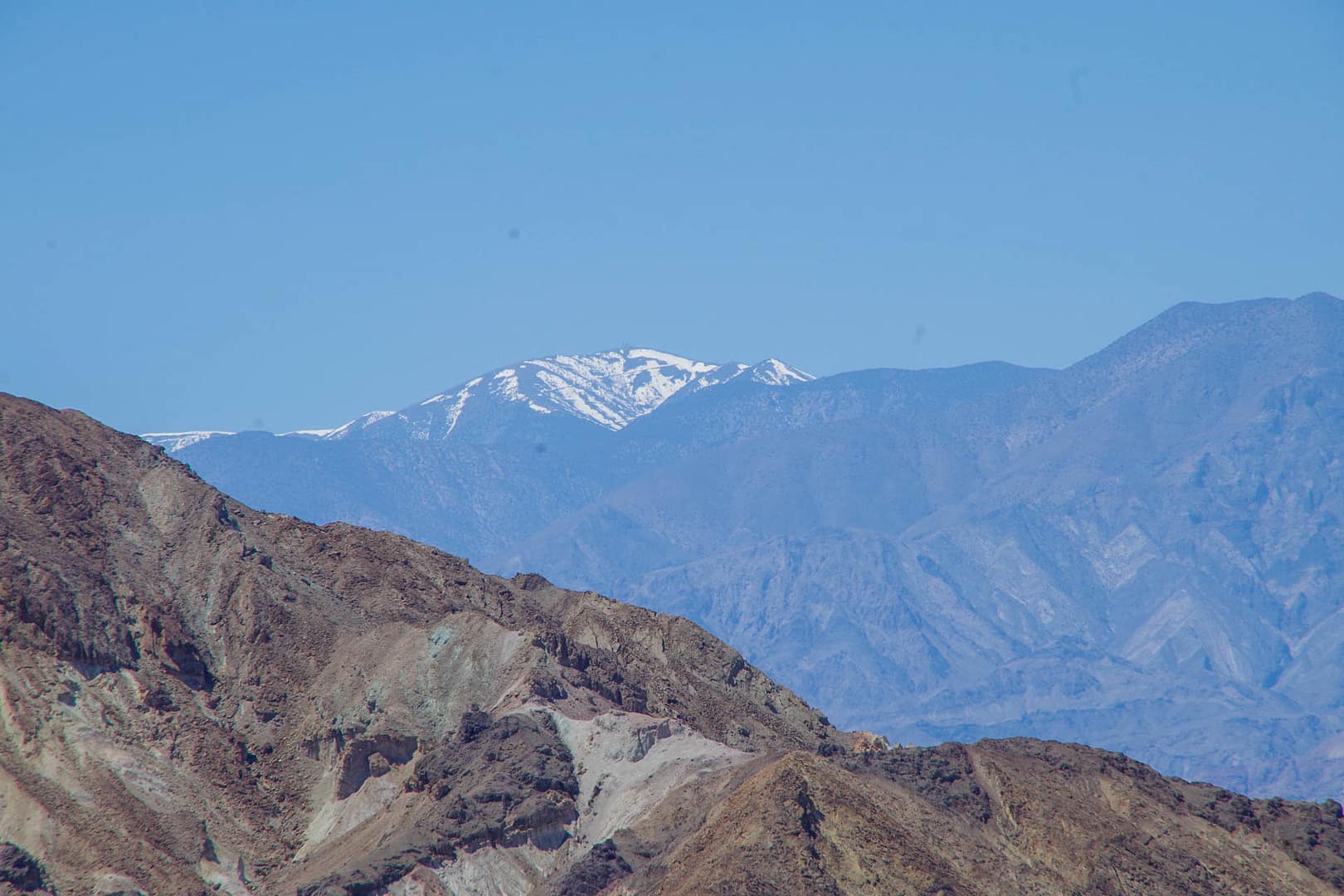 rocks with snowcapped mountains