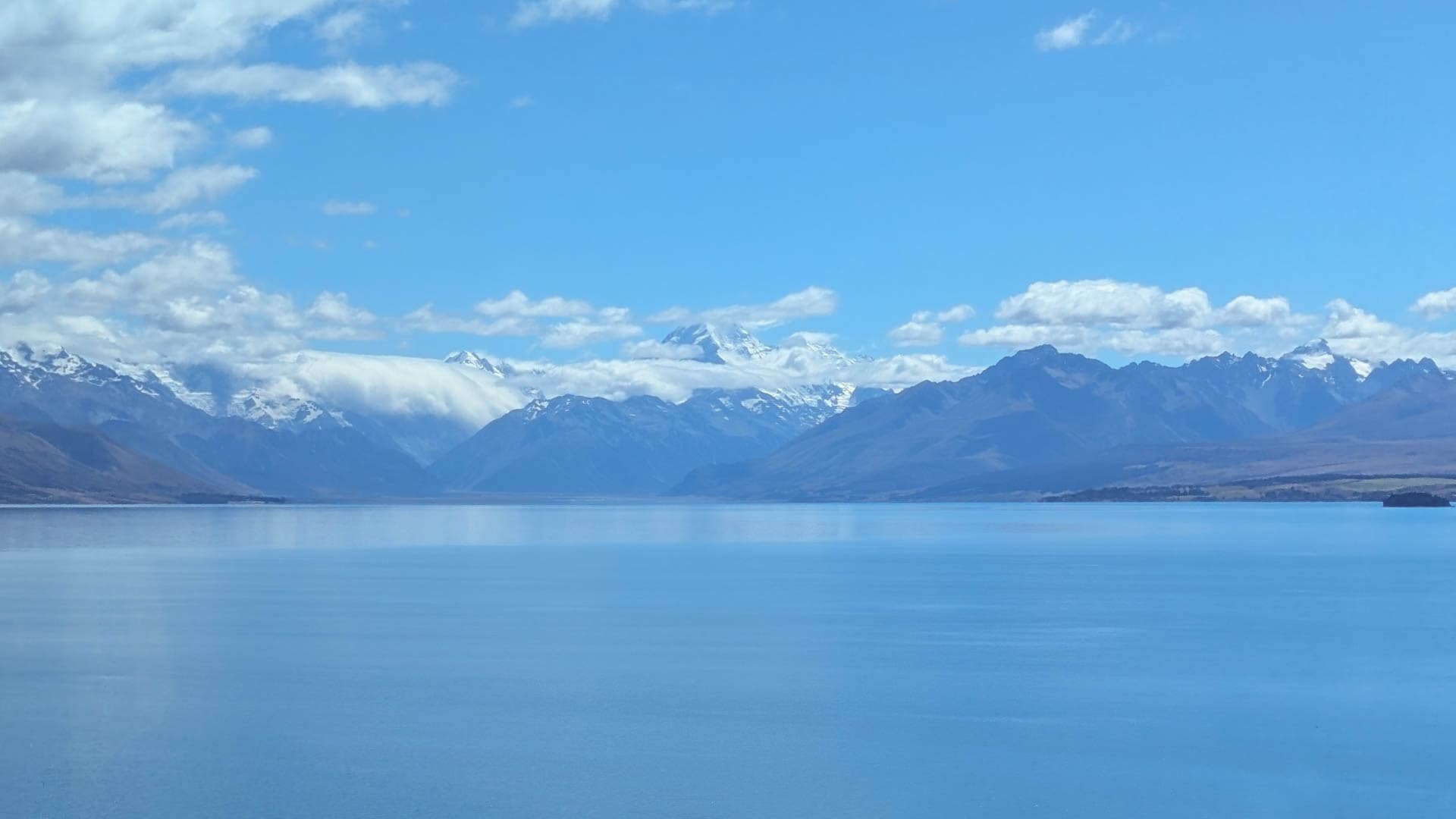 glacial lake with mountains beyond