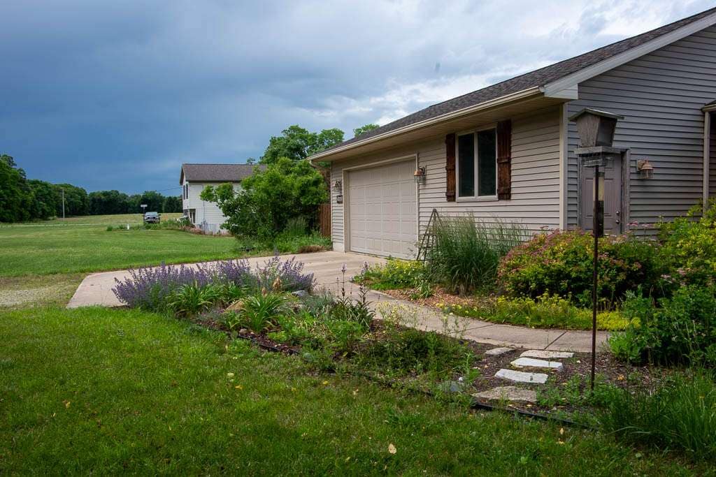 Foundation2026-02 garage and sidewalk with plants