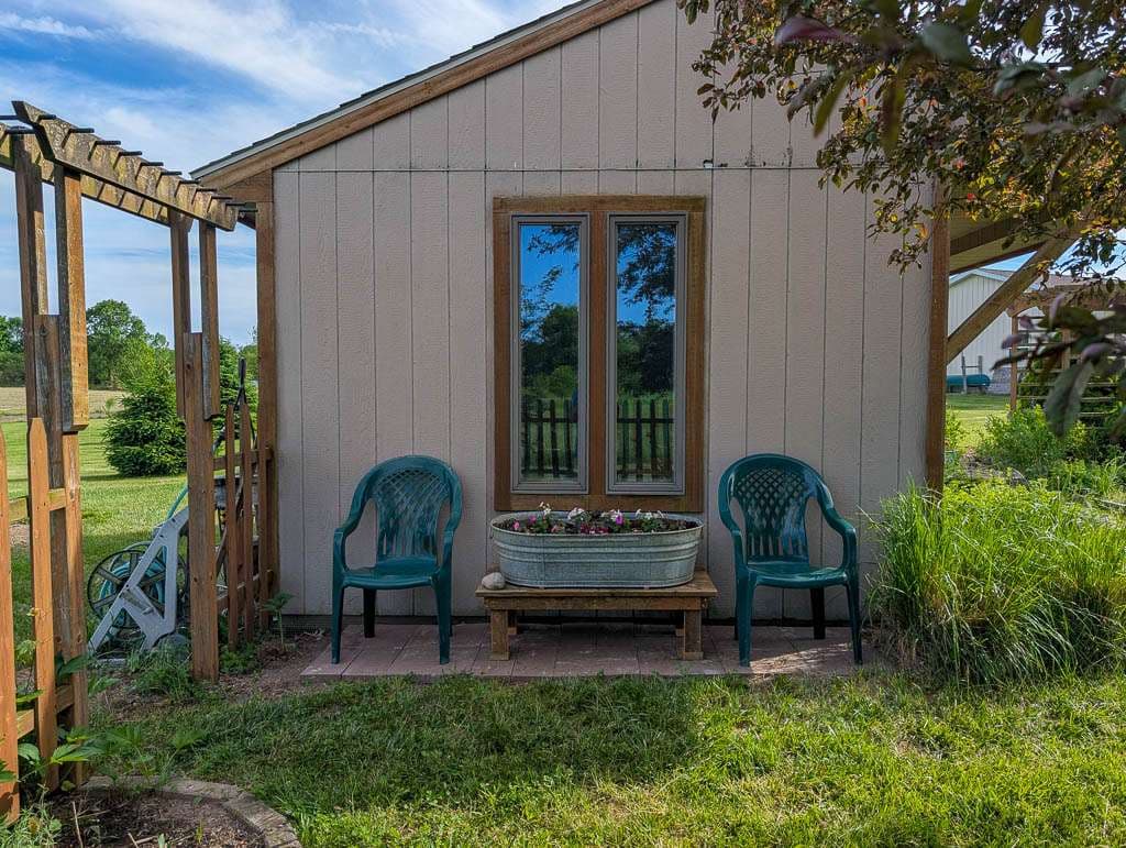 May2026-11 shed with window and seating area