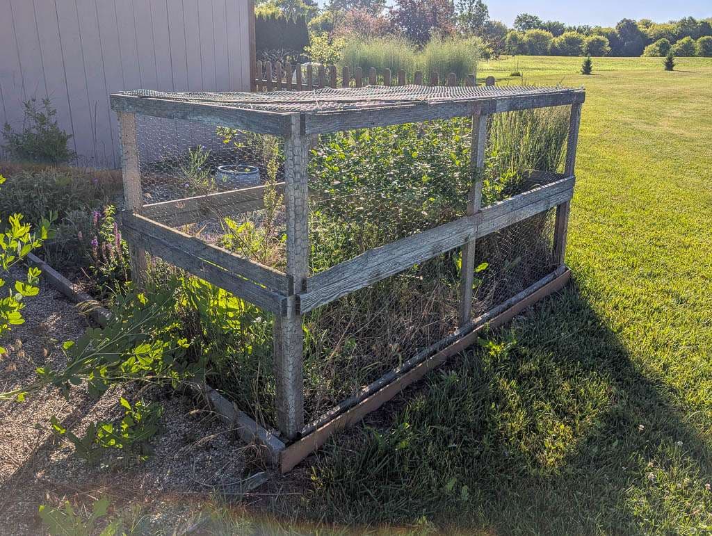 cage of old wood and chicken wire
