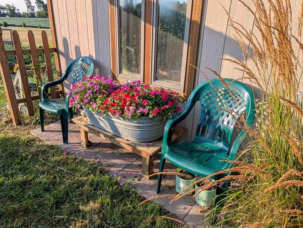 chairs and flowering container next to shed