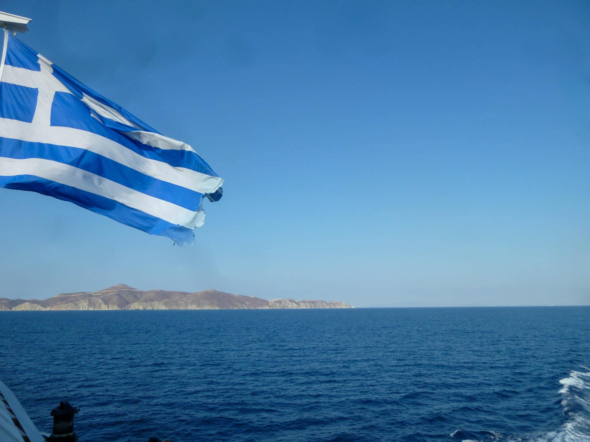 Greek flag over water