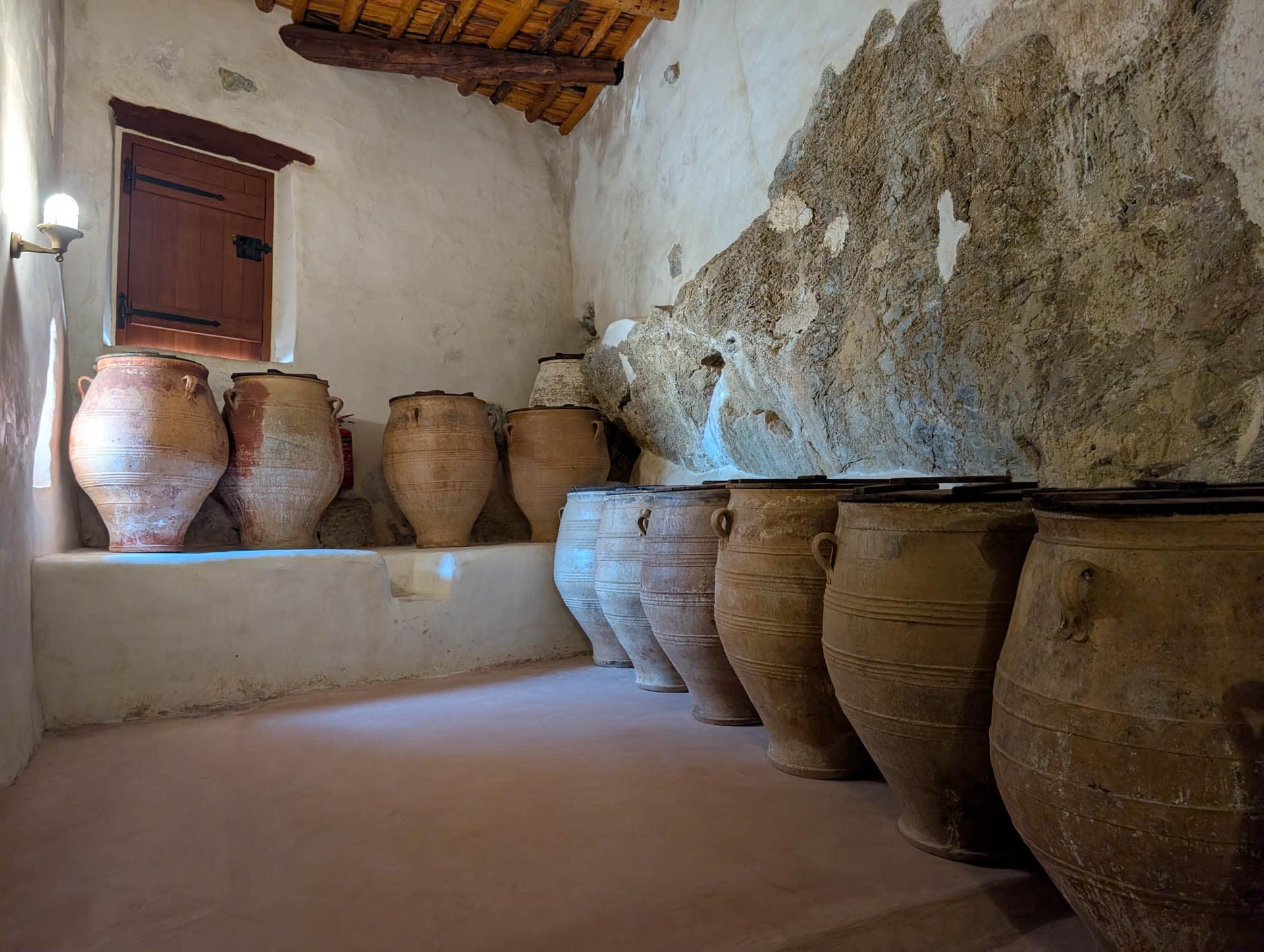 large urns against rock wall