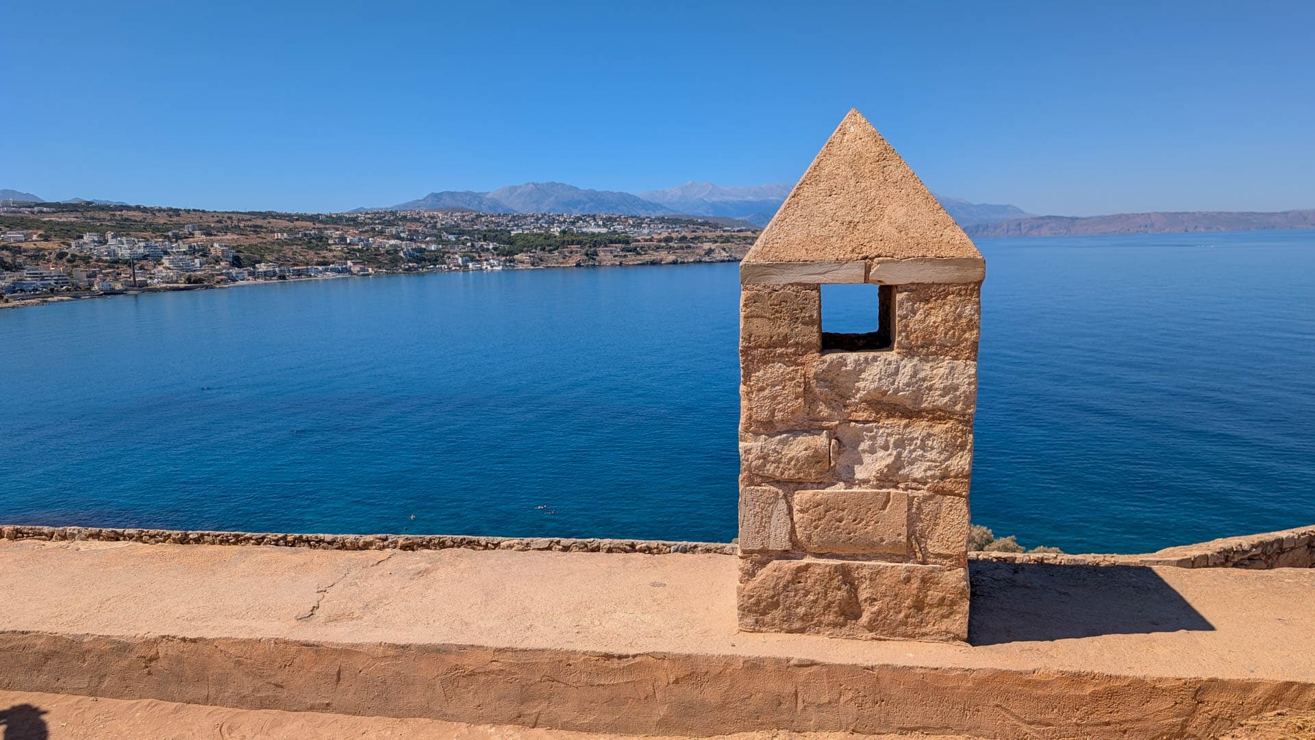 short tower with water in background